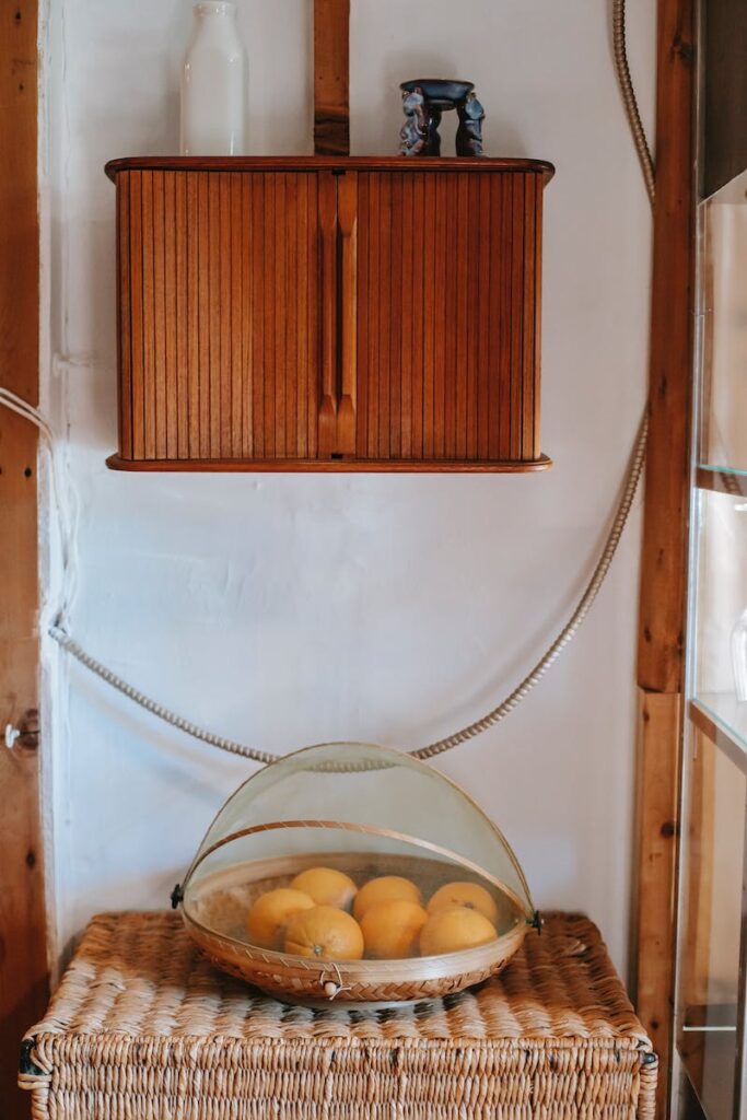 Part of vintage interior with wicker boxes and platter with oranges