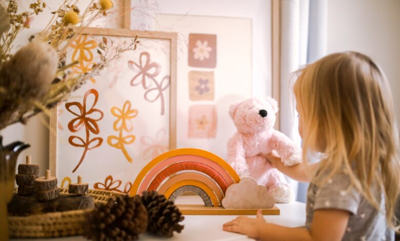 girl wearing grey shirt standing near framed artwork