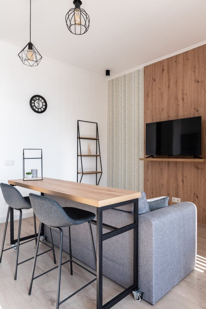 Apartment with table and chairs near couch with TV