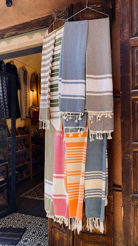 a row of towels hanging on a clothes rack