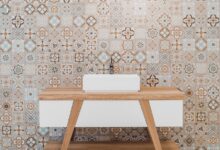 brown wooden table beside white and black wall